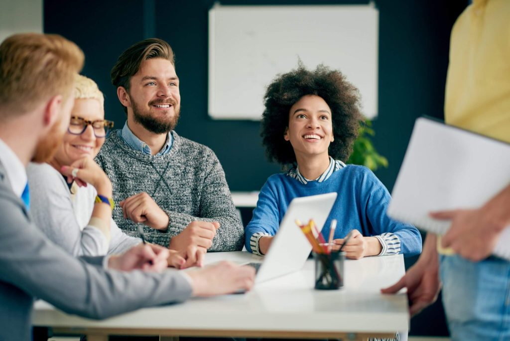 Multi ethnic team having presentation/ meeting in modern office