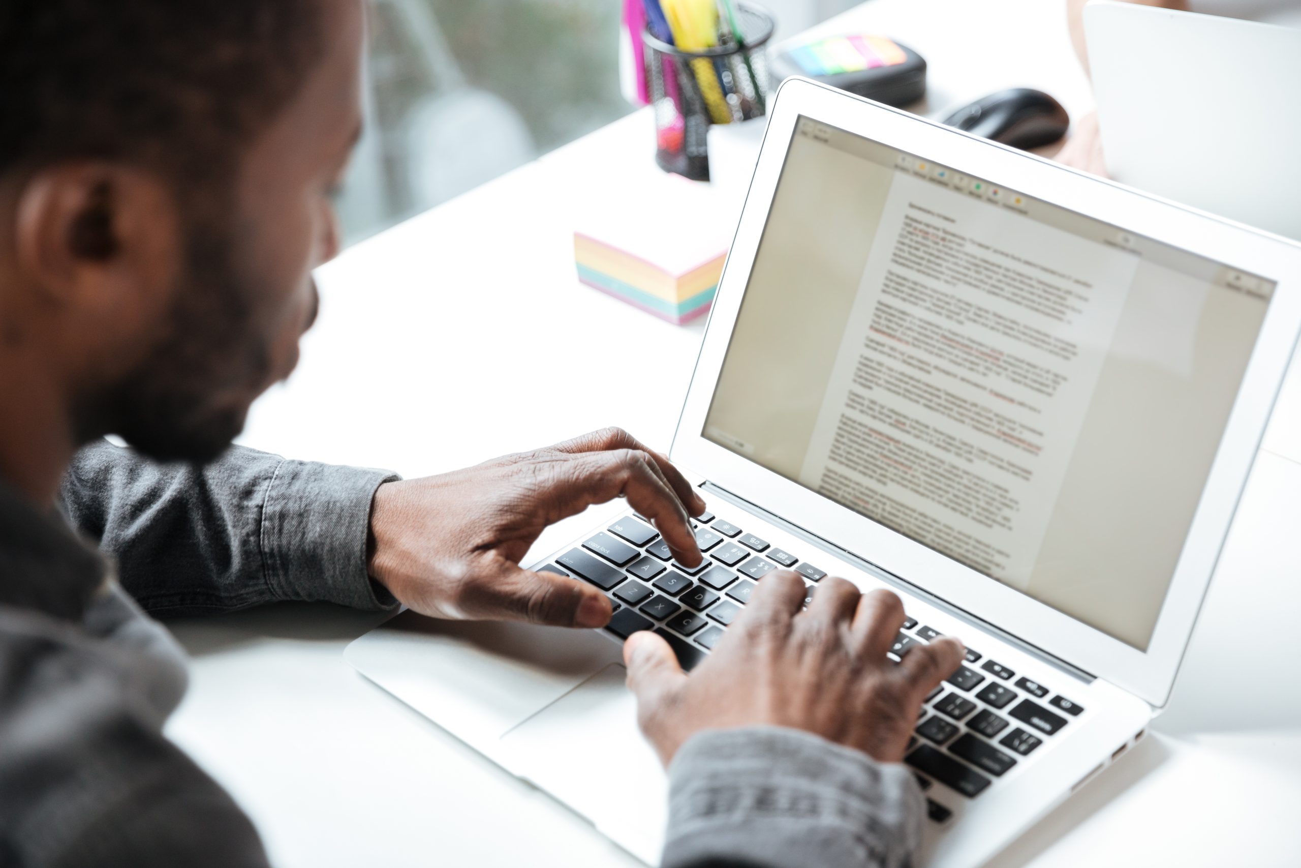 Man working on document on laptop