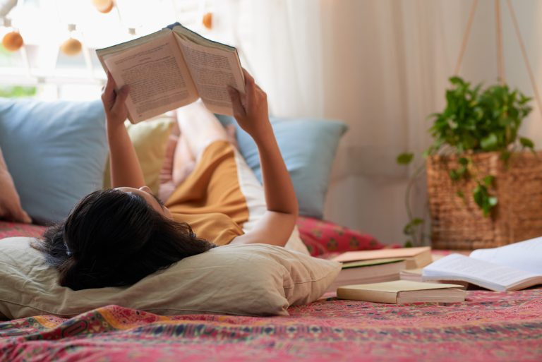 Woman lying down reading.