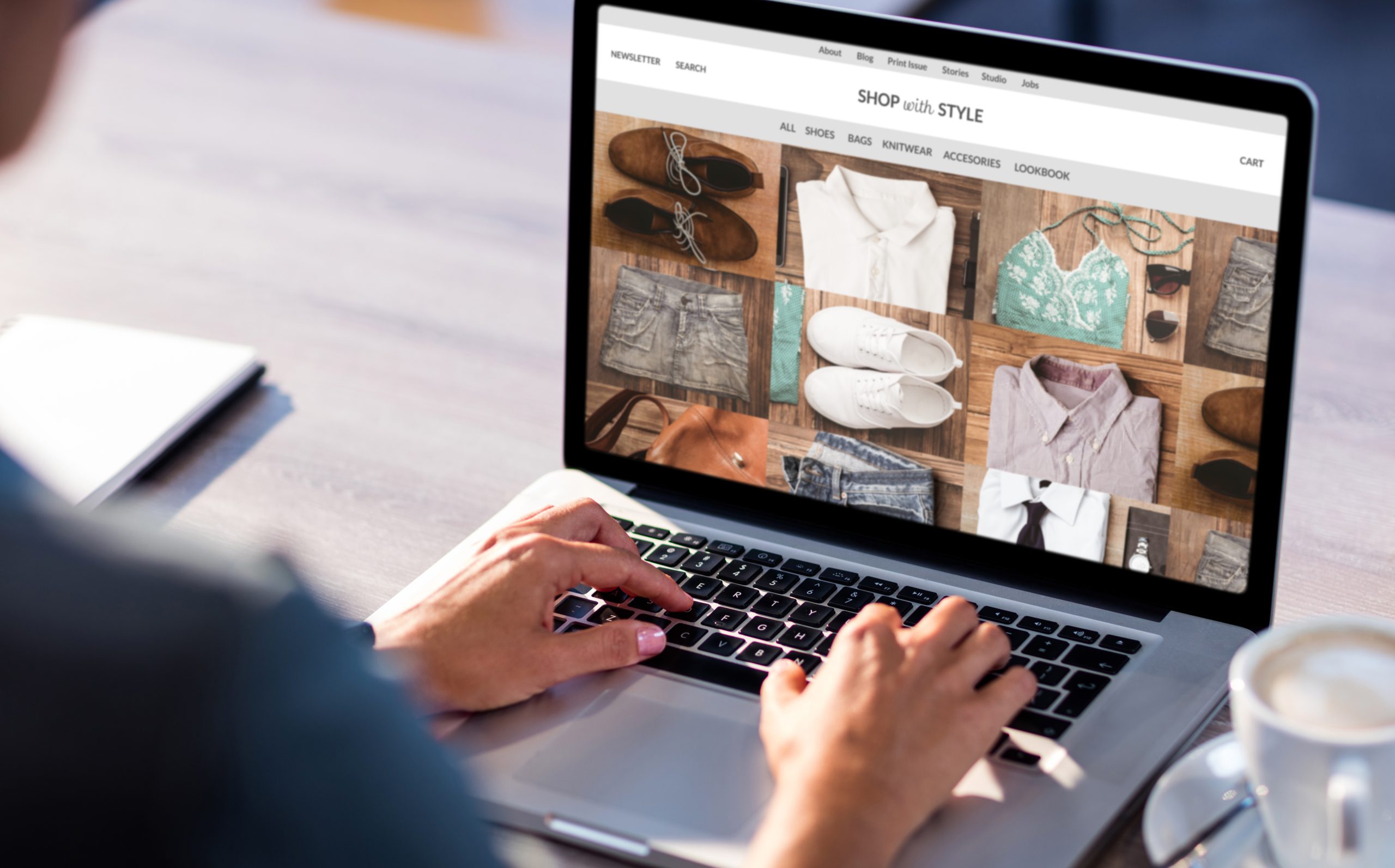 Woman on ecommerce clothes website homepage on laptop