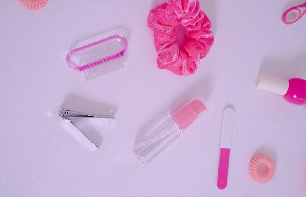 Pink beauty accessories on a white surface.