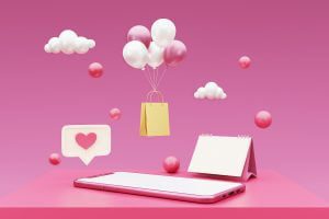 Pink balloons floating with a shopping bag above a pink tablet.