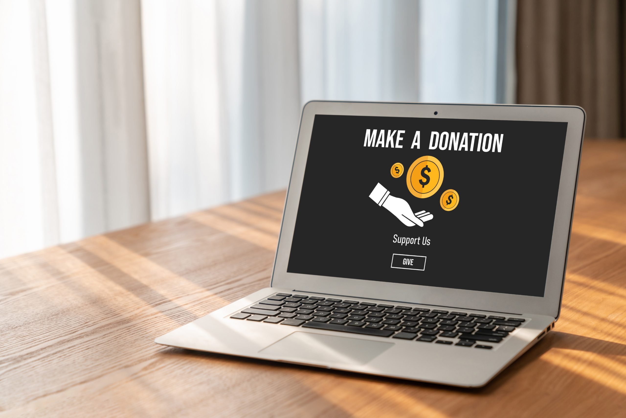 Computer on table with 'Make a donation' on the screen