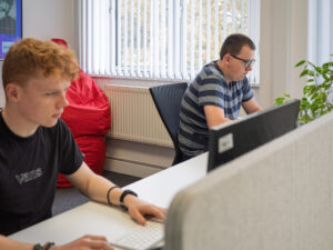 Two people working at desks